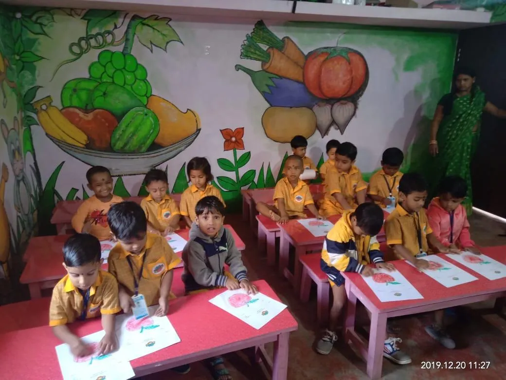 Children drawing at classroom tables