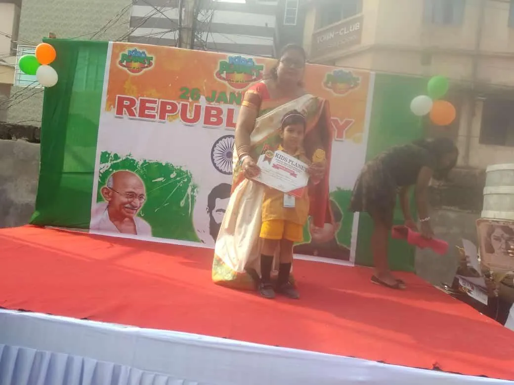 A child receiving a certificate at a school event