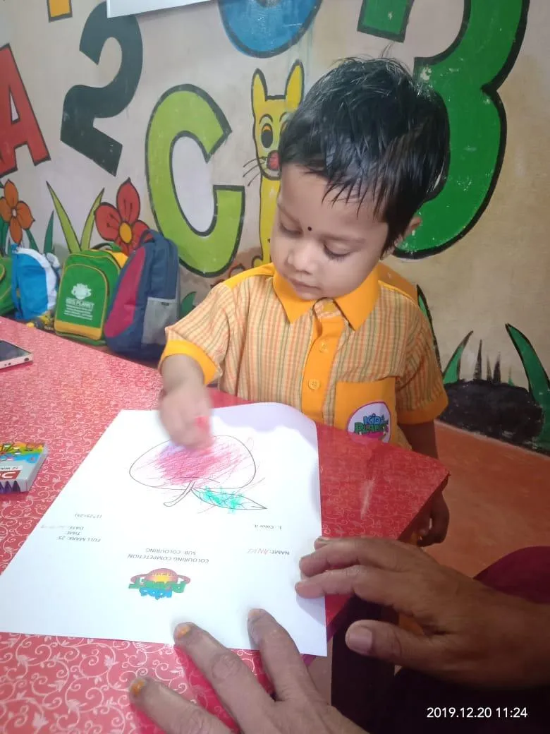 A child concentrating on a colouring activity