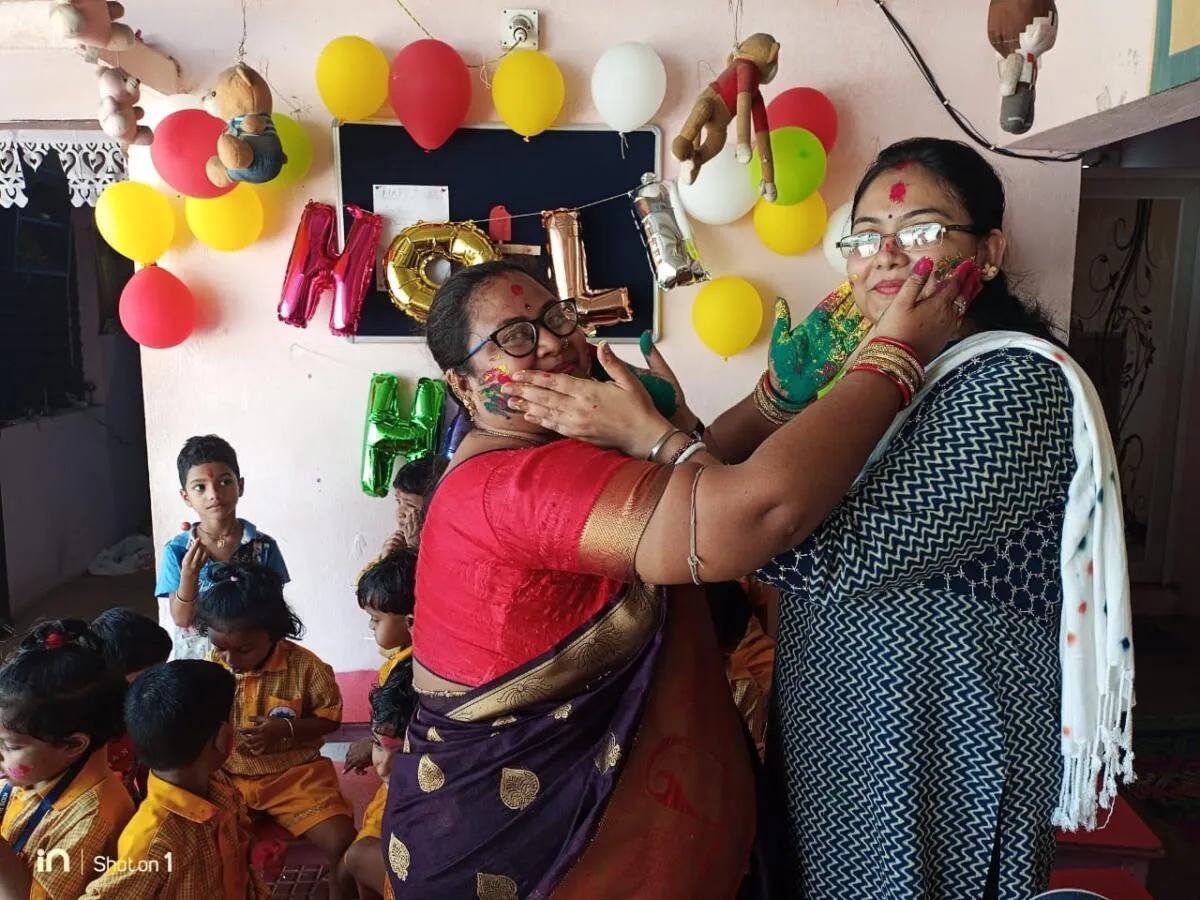 Teachers sharing a Holi celebration