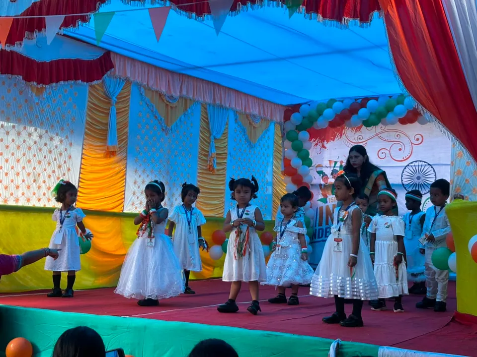 Children performing on a tricolour-decorated stage at Kids Planet